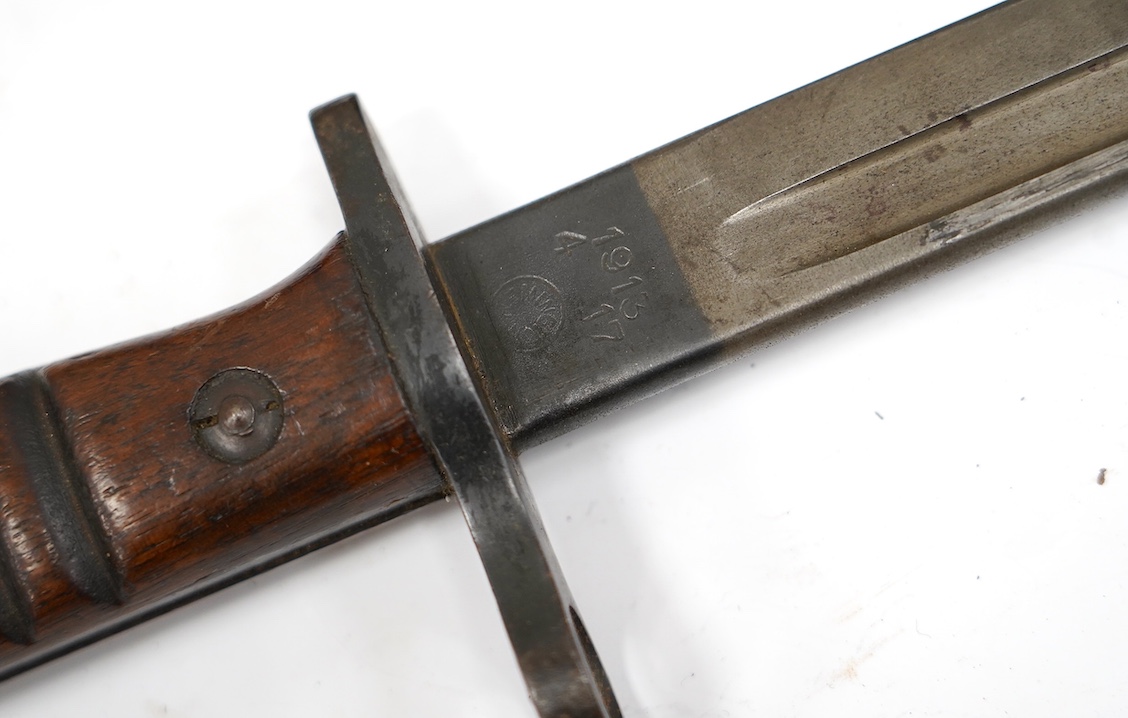 Two bayonets; a good Remington bayonet dated 1913 in its leather scabbard with khaki frog dated 1940, and a Gras bayonet dated 1880. Condition - good